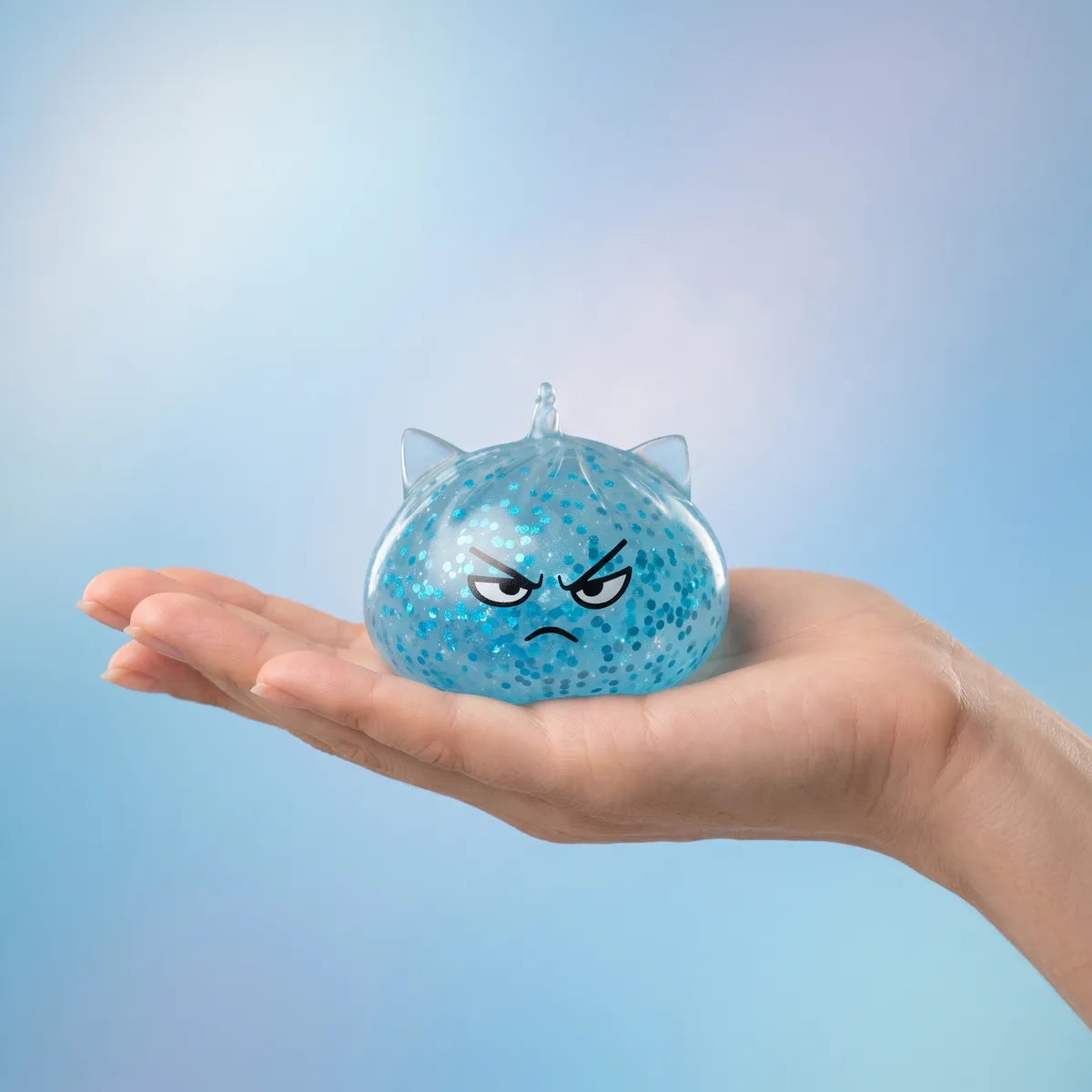 Unicorn glitter mystery dumpling squishy held in hand