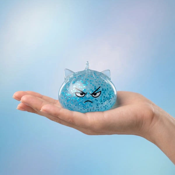 Unicorn glitter mystery dumpling squishy held in hand