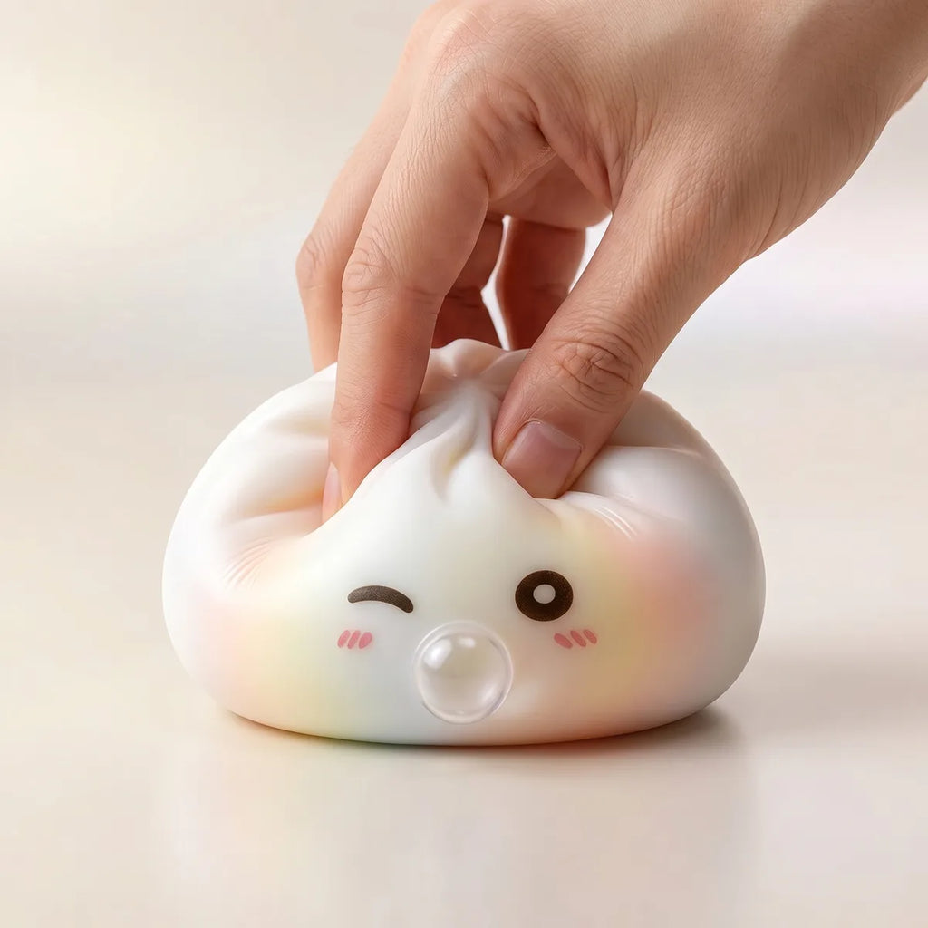 Hands playing with the mystery dumpling squishy toys