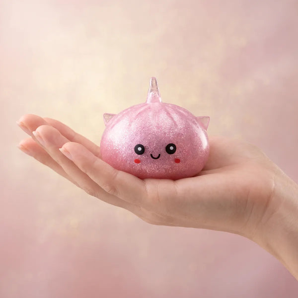 Unicorn glitter mystery dumpling squishy held in hand