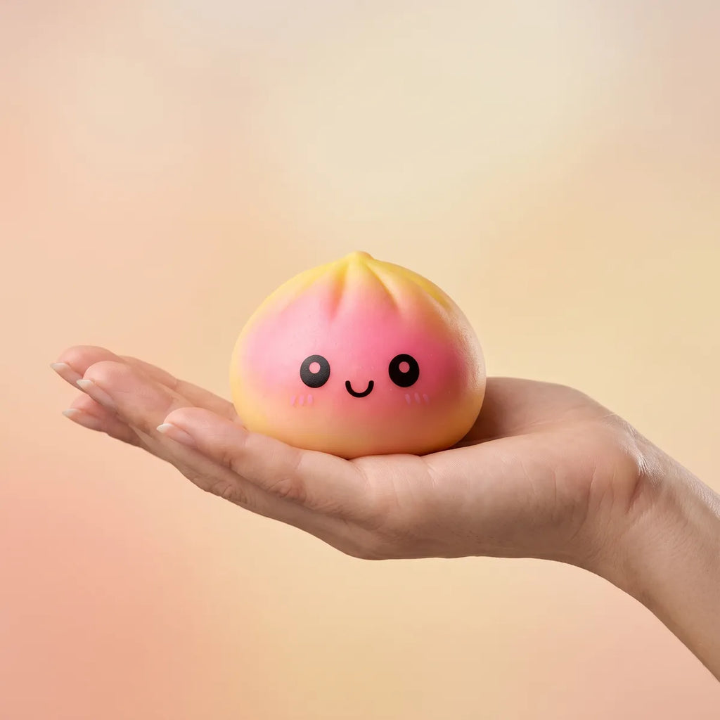 Hand holding a fade dumpling squishy