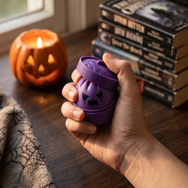 Person squeezing a mystery ghost dumpling squishy as a Halloween fidget toy