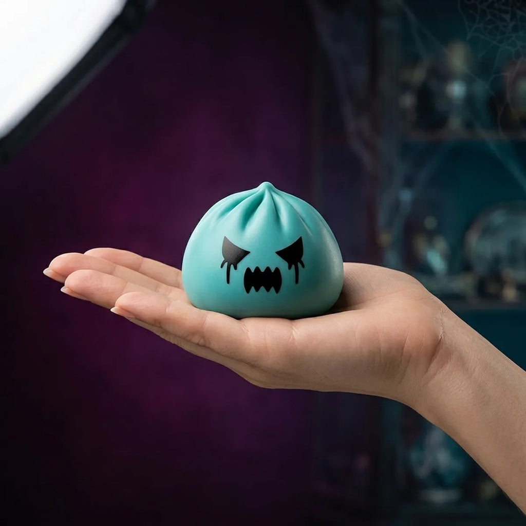 Hand holding a 5.5 cm mystery ghost dumpling squishy to show its mini size