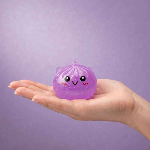 Hand holding a mini unicorn dumpling squishy