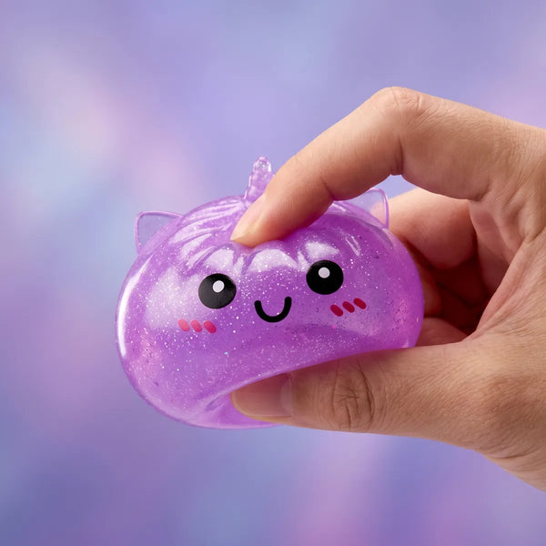 Hand squeezing a mini unicorn dumpling squishy