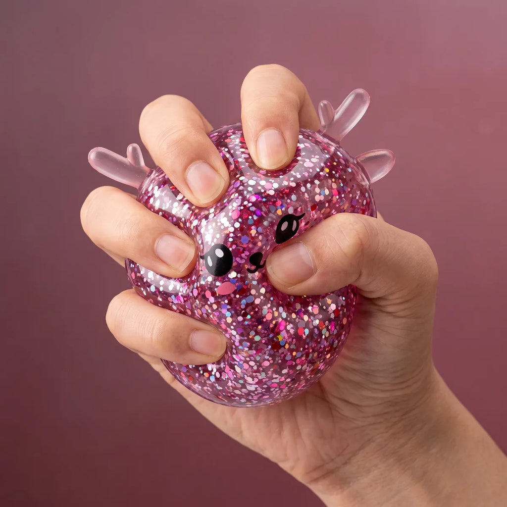 Hand squeezing the Twinkling Mystery Reindeer Dumpling Squishy