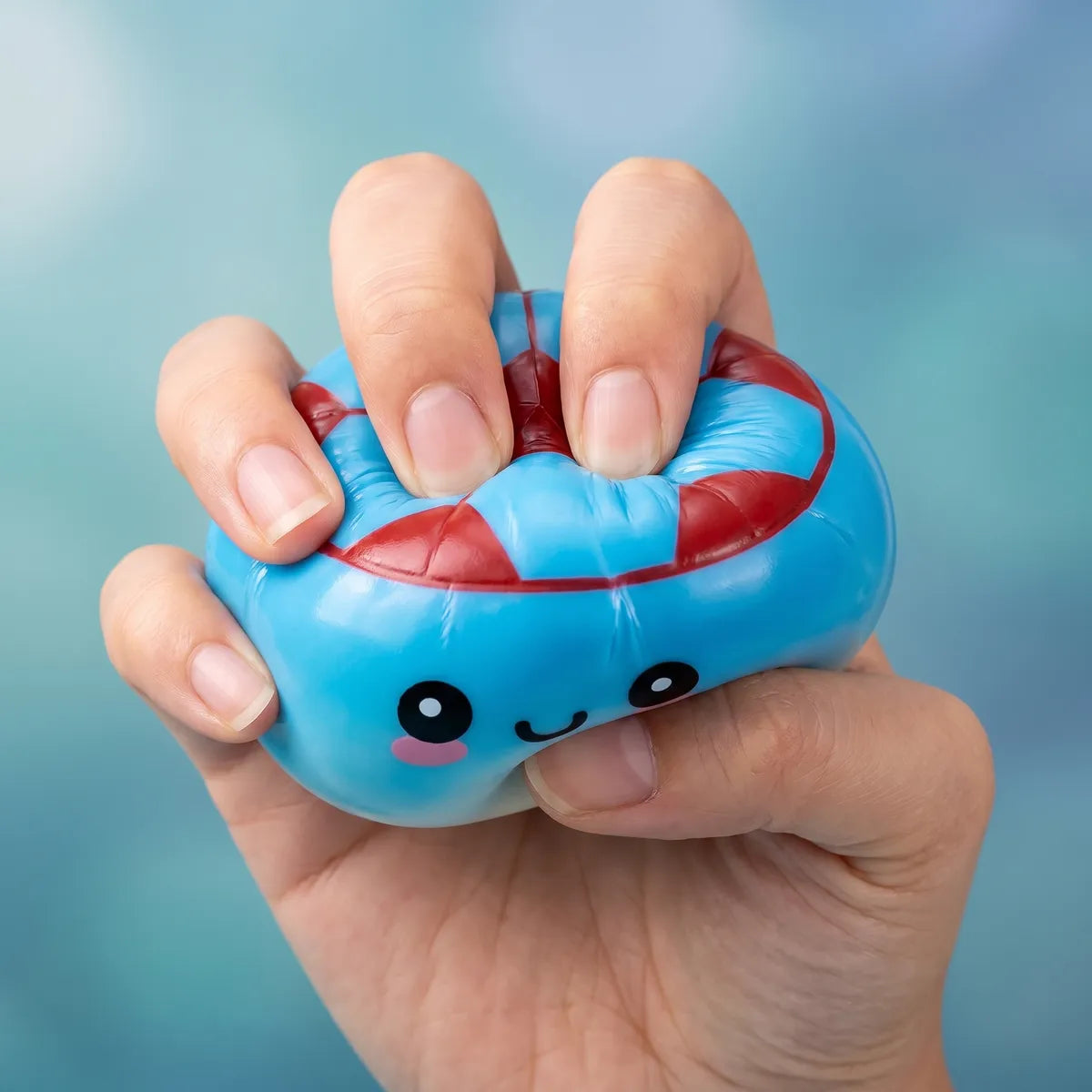 Hands playing with the mystery soccer dumpling squishy