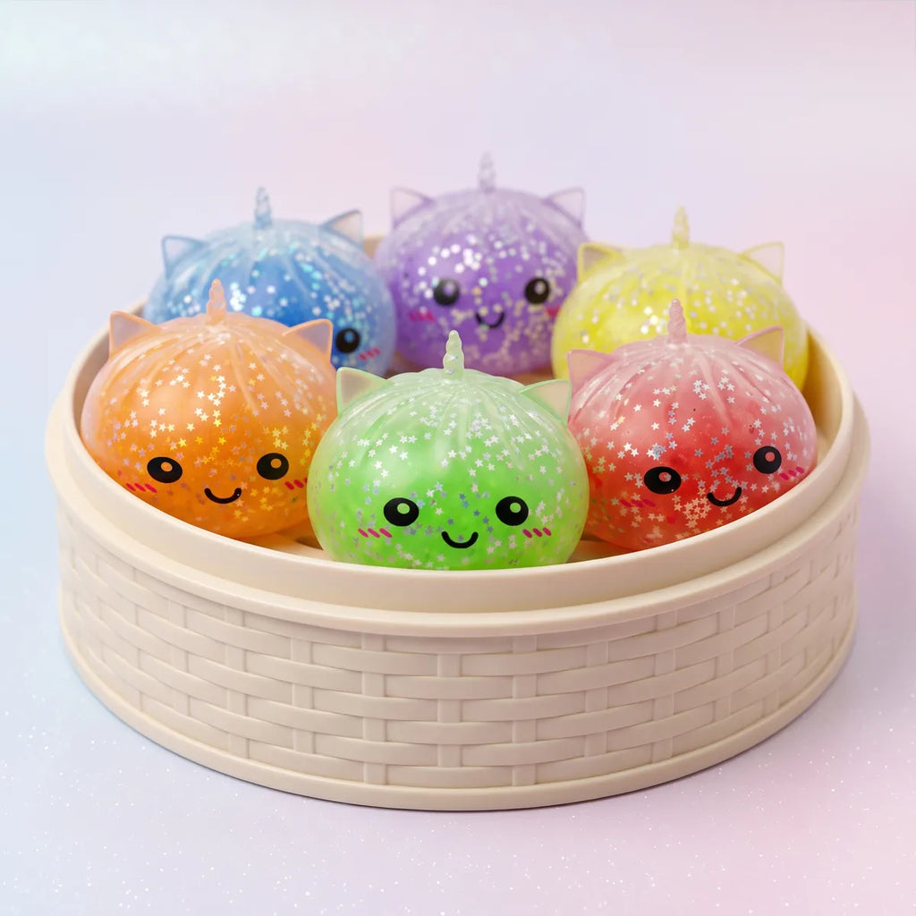 Sparkle unicorn dumpling squishies packed inside the mini bamboo steamer mystery box