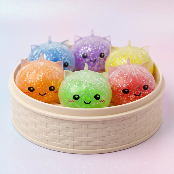Sparkle unicorn dumpling squishies packed inside the mini bamboo steamer mystery box