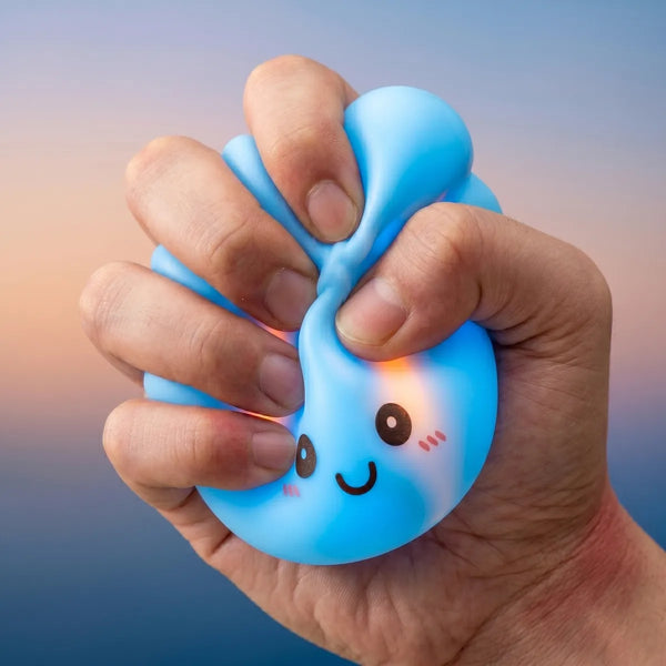 Hands playing with the mystery squishy dumpling night light
