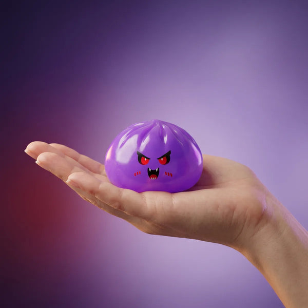 Hand holding an 8 cm mystery vampire dumpling squishy to show its size