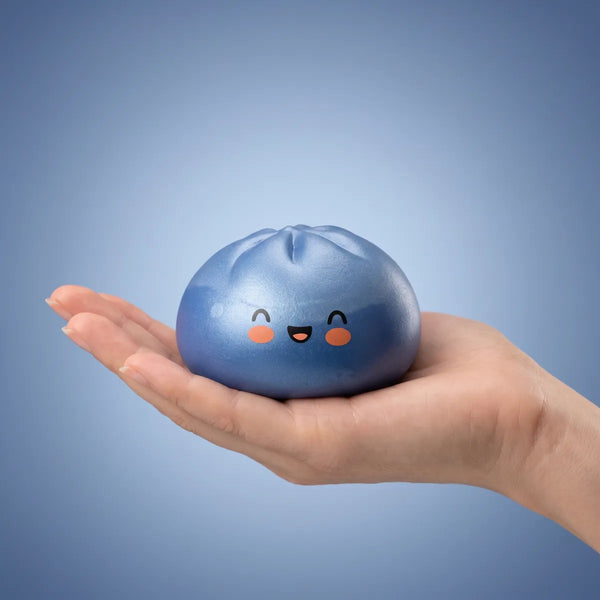 Hand holding a navy blue dumpling squishy
