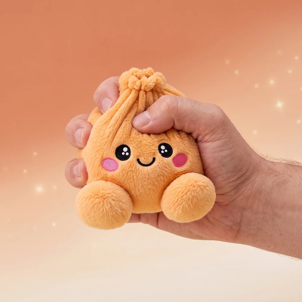 Hand gripping and squishing the Tangerine Orange Dumpling Squishy Plush