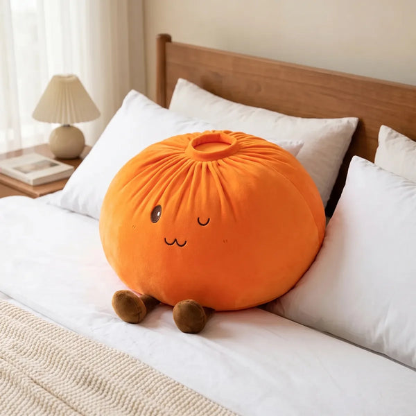 Orange large dumpling squishy plush pillow in a cozy bedroom