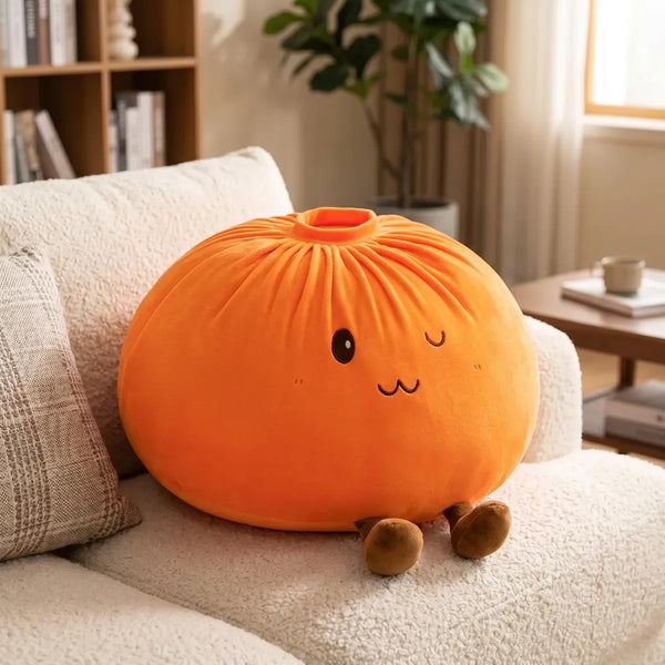 Orange large dumpling squishy plush pillow styled on a sofa