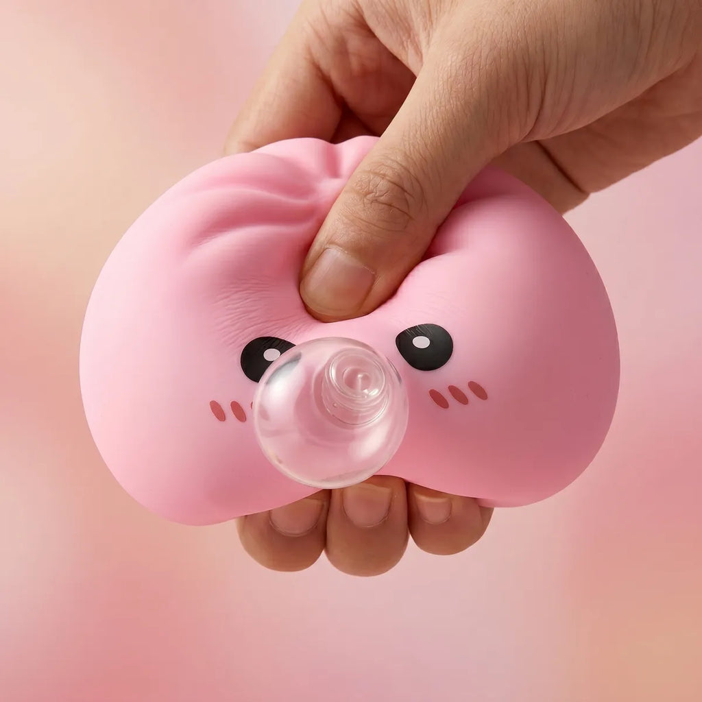 Hands playing with the pink blow dumpling squishy