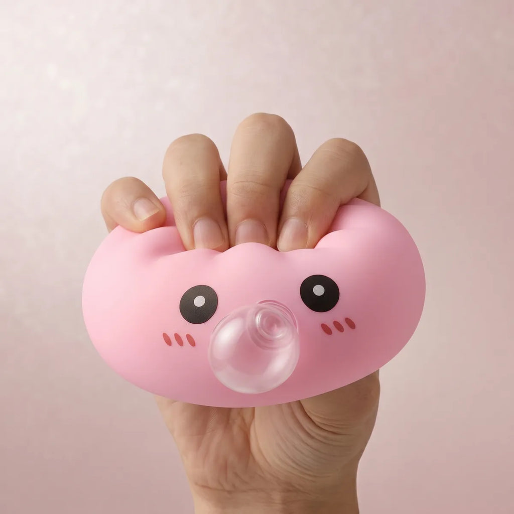 Pink blow dumpling squishy being squeezed showing slow rising foam