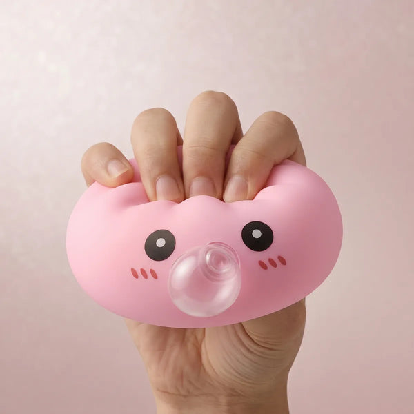Pink blow dumpling squishy being squeezed showing slow rising foam