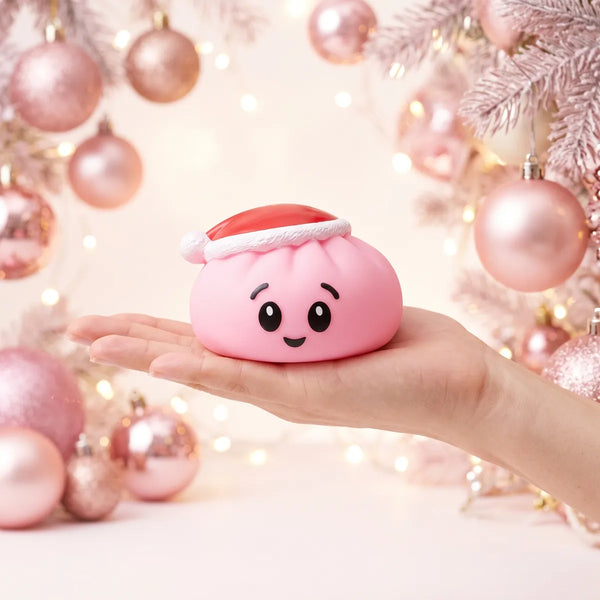 Sugar Pink Christmas Hat Dumpling Squishy resting on an open palm to show its real size