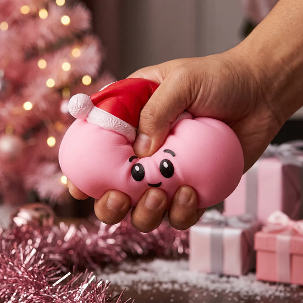 Hand squeezing the Sugar Pink Christmas Hat Dumpling Squishy