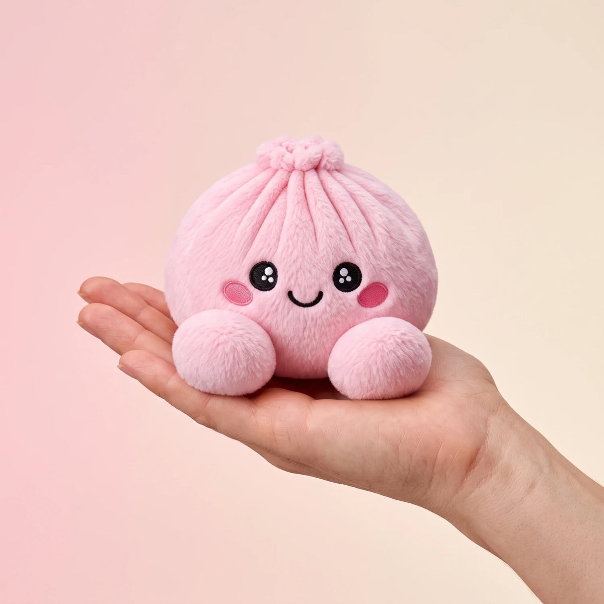 Peony Pink Dumpling Squishy Plush resting on an open palm to show its real size