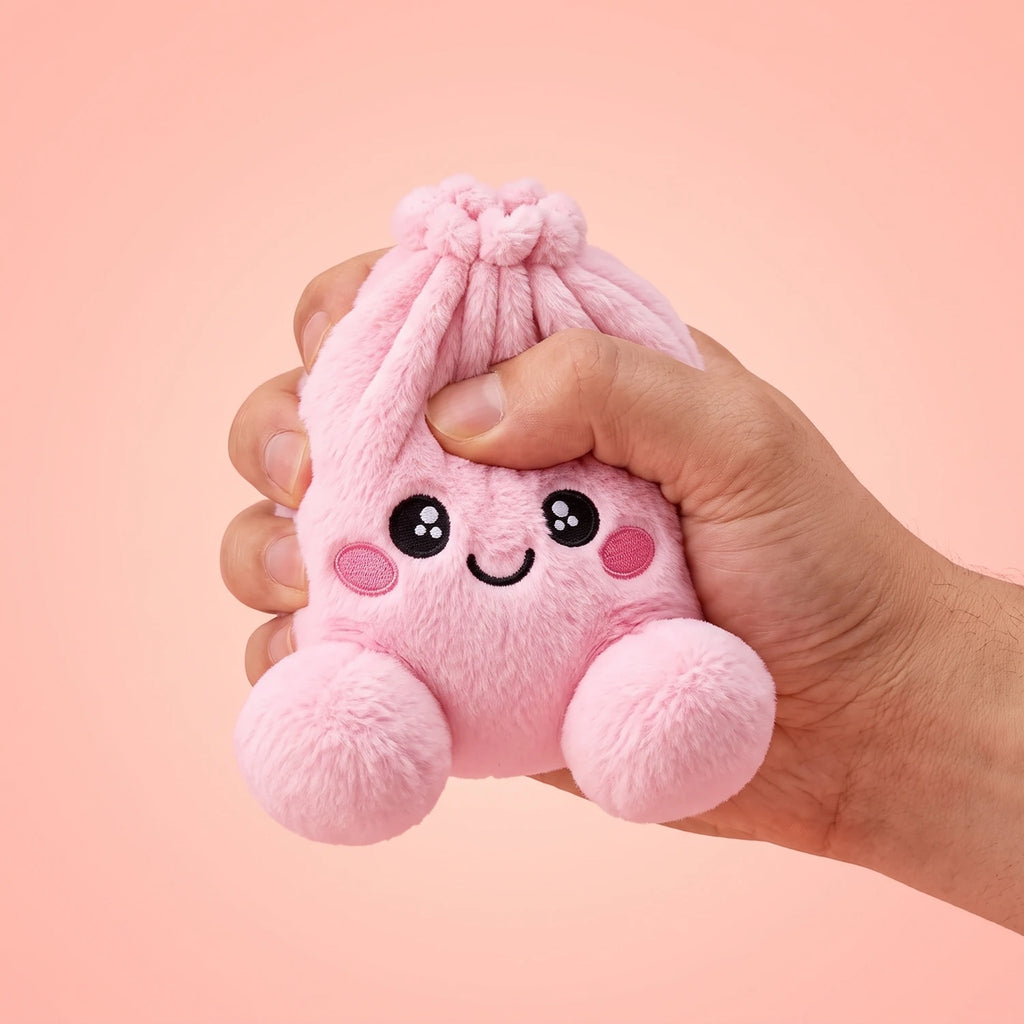 Fingers pinching the Peony Pink Dumpling Squishy Plush to show how soft it is