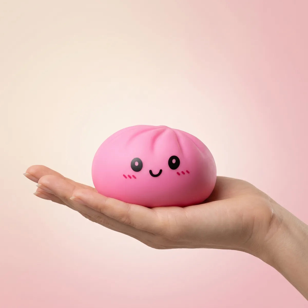 Pink dumplings squishy held in hand lifestyle shot