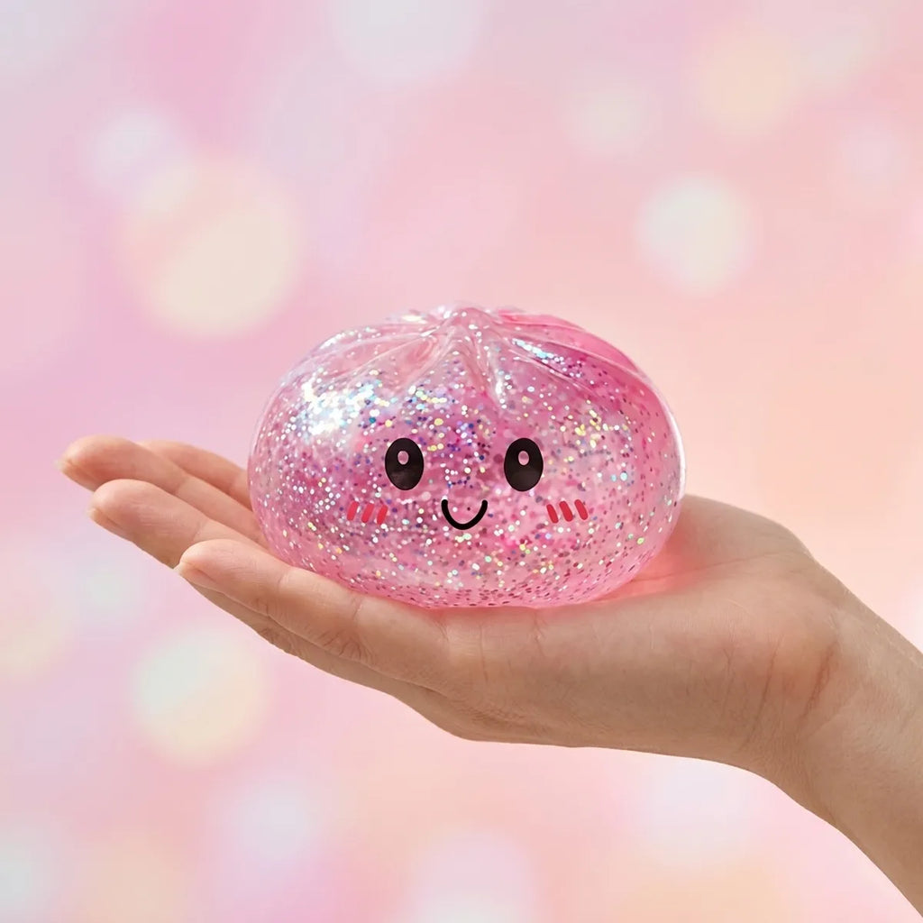 Hand holding a soft pink glitter dumpling squishy