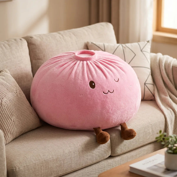 Pink large dumpling squishy plush pillow styled on a sofa
