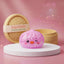 Pink penguin dumpling squishy in marbled candy pink winking on a white podium