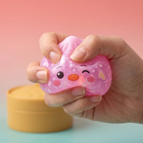 Close up squeeze of the pink penguin dumpling squishy showing its white marbled swirl