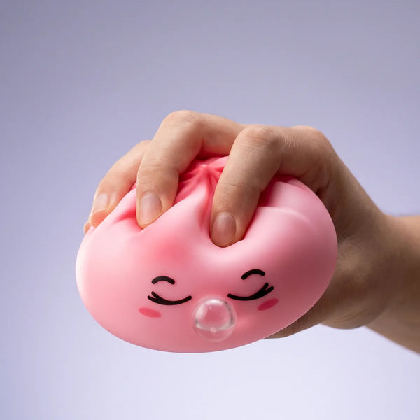 Pink rare blow dumpling squishy slowly rising back to shape