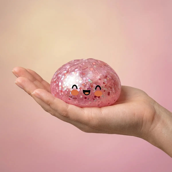 Hand holding a pink sparkle dumpling squishy