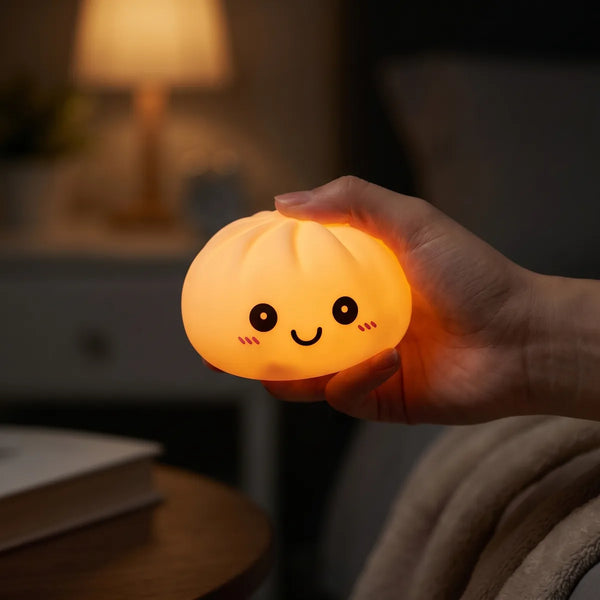 Pink squishy dumpling light glowing softly in a dark room