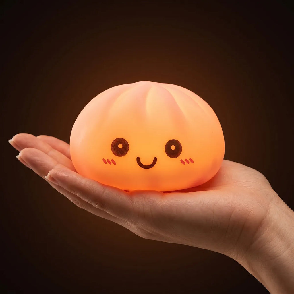 Pink squishy dumpling light held in hand