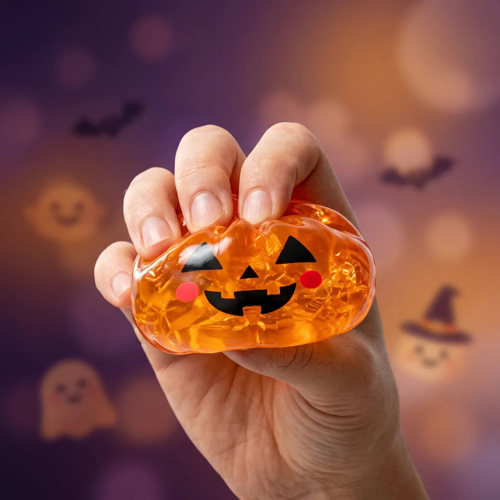 Pumpkin Halloween dumpling squishy squeezed flat to show its slow rising amber gel