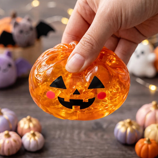 Close up squeeze showing the translucent glitter fill of the pumpkin Halloween dumpling squishy