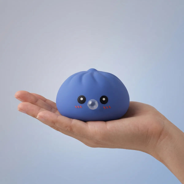 Purple blow dumpling squishy held in hand