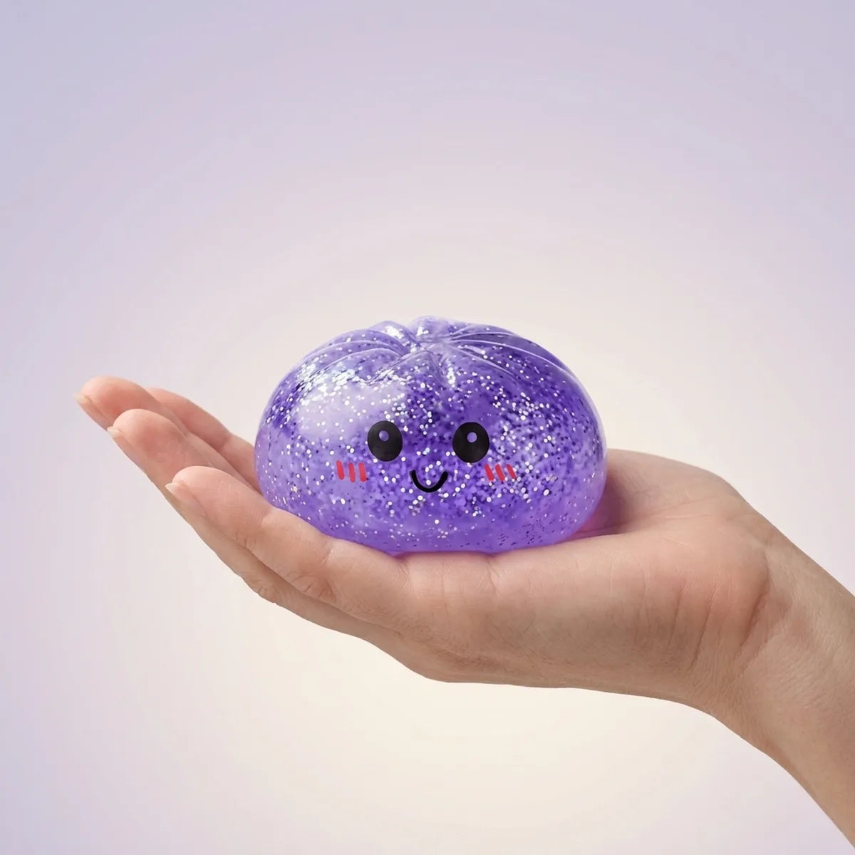 Hand holding a soft purple glitter dumpling squishy