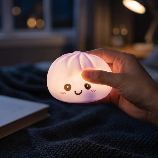 Purple squishy dumpling light glowing softly in a dark room