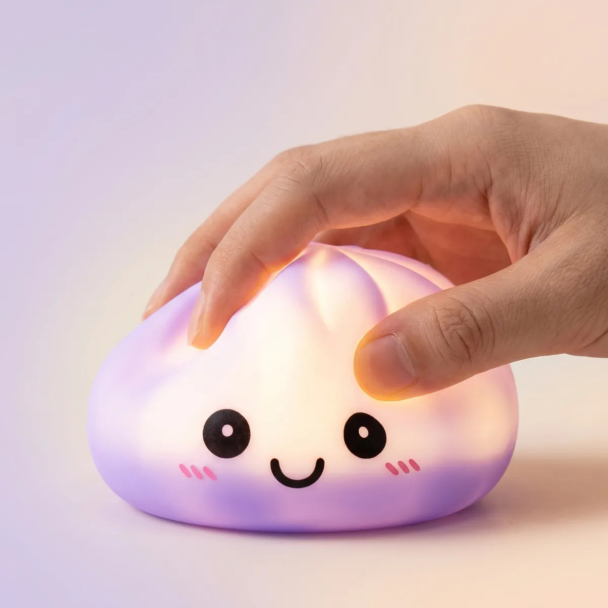Hands playing with the purple squishy dumpling light