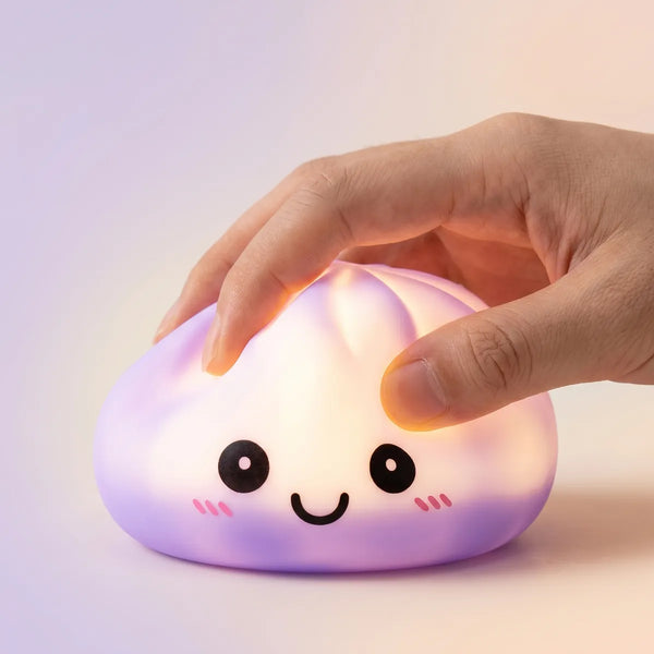 Hands playing with the purple squishy dumpling light