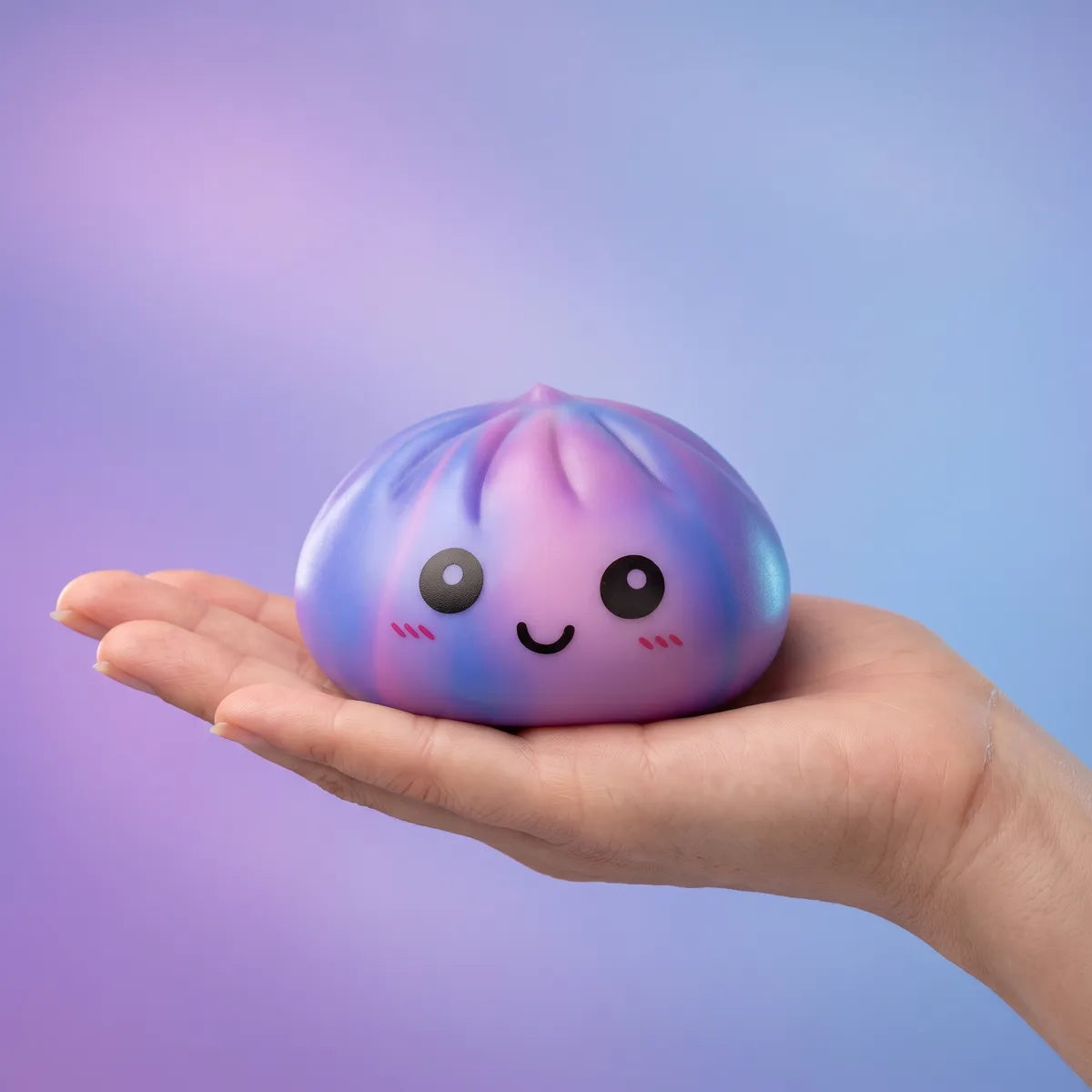 Hand holding the 8.5 cm purple tie dye dumpling squishy to show scale