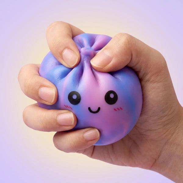 Purple tie dye dumpling squishy pressed flat to demonstrate its slow rising squish