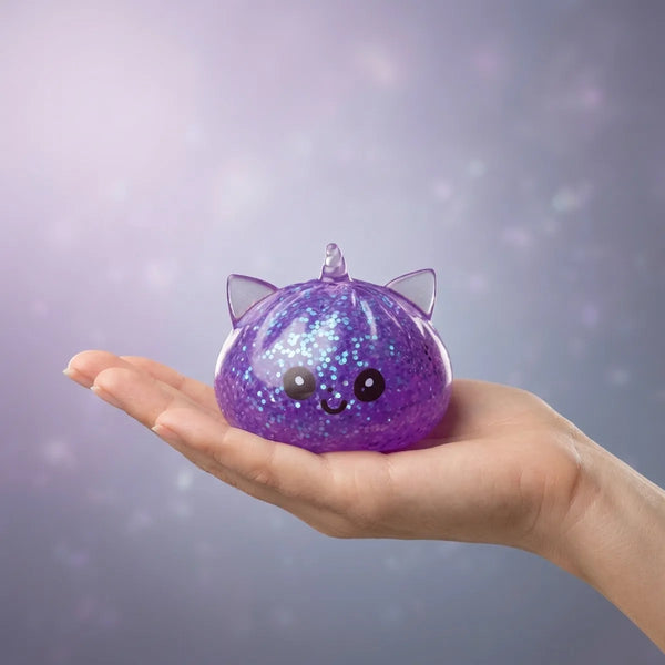 Hand holding the 5.5 cm purple unicorn glitter dumpling squishy to show its size