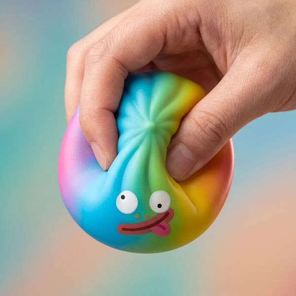 Rainbow mystery squishy dumpling being squeezed showing slow rising foam