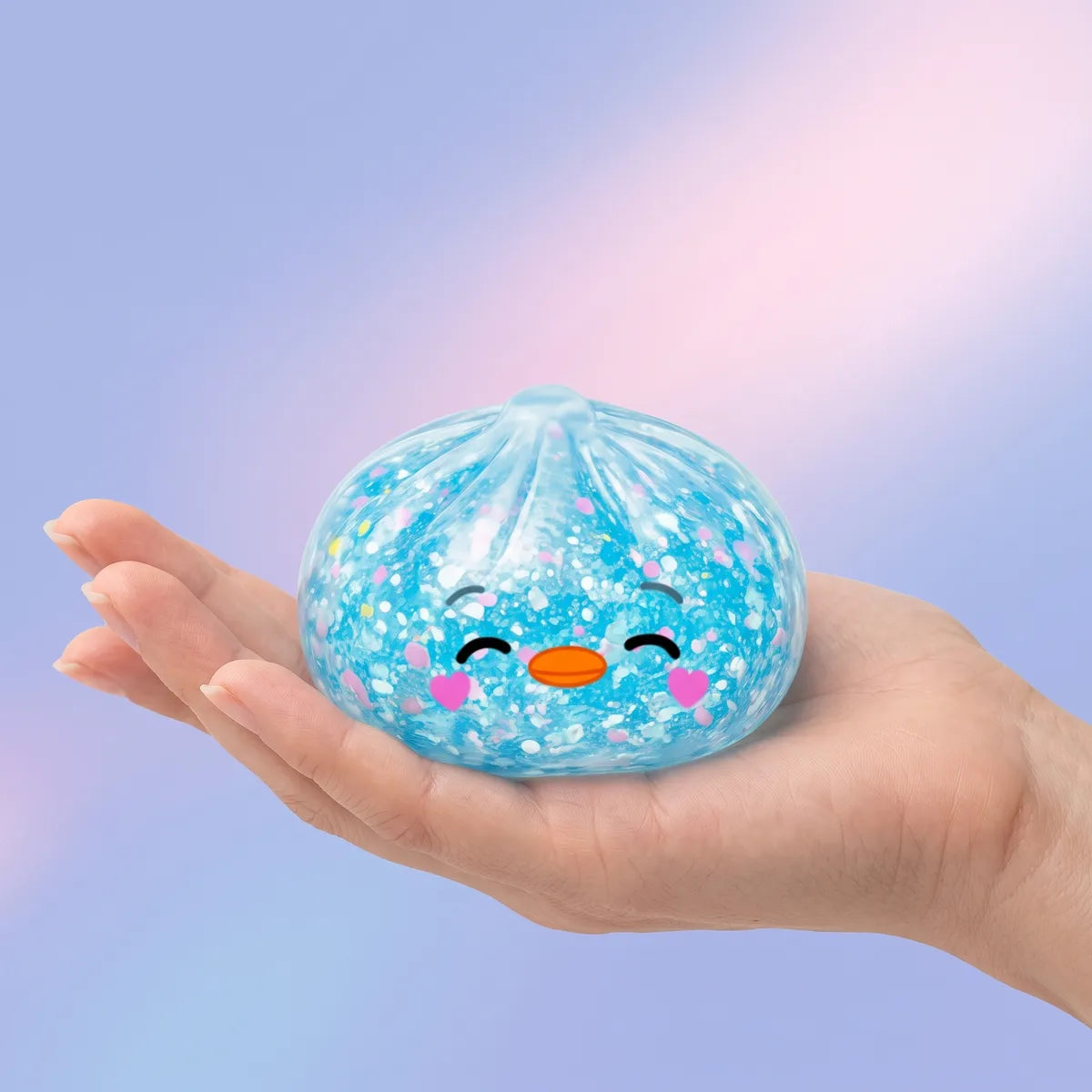 Hand holding the 5.5 cm rare blue penguin dumpling squishy to show its size