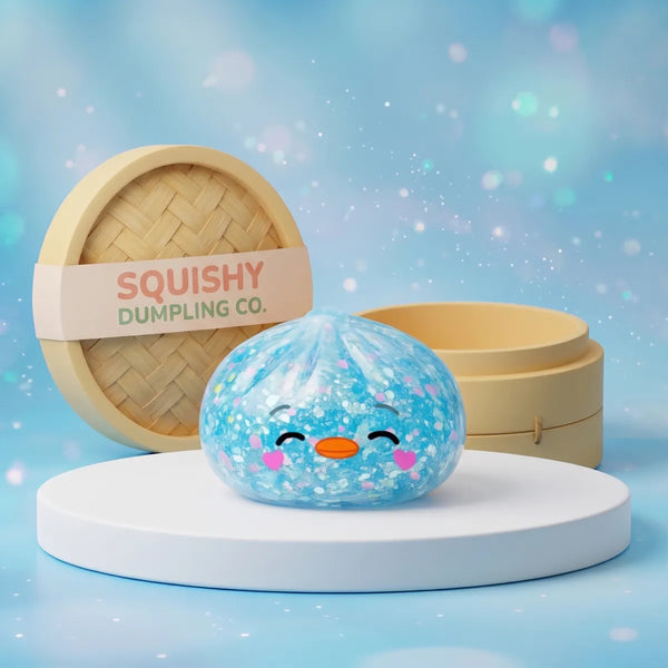 Rare blue penguin dumpling squishy with heart cheeks and confetti fill on a white podium