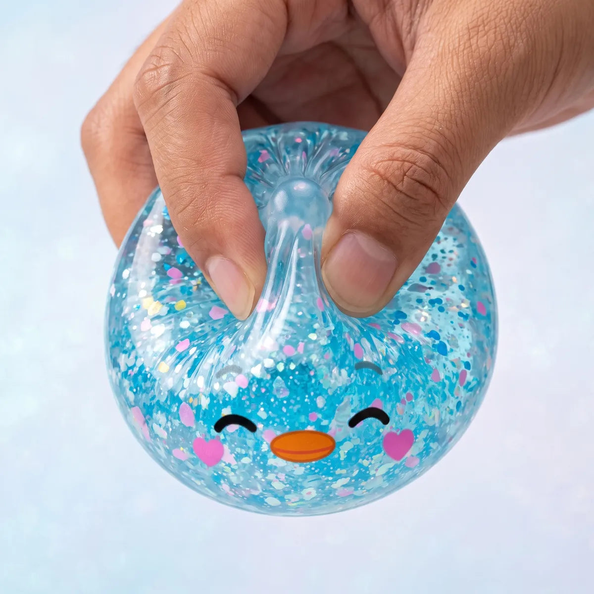 Macro squeeze of the rare blue penguin dumpling squishy showing its sky blue glitter