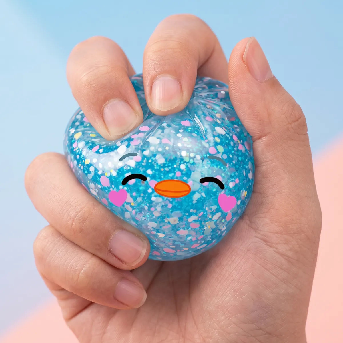 Hand squeezing the rare blue penguin dumpling squishy to show its slow rise